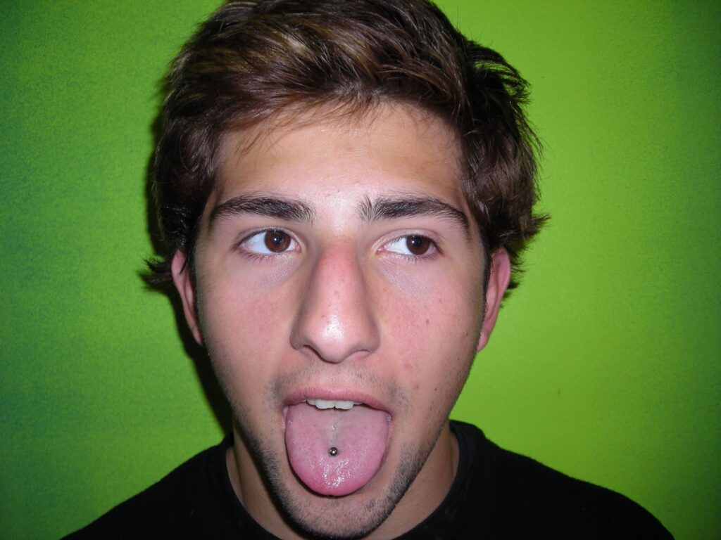 Healed tongue piercing featuring a downsized titanium barbell from Valhalla Treasures, illustrating the evolution of piercing techniques and jewelry.