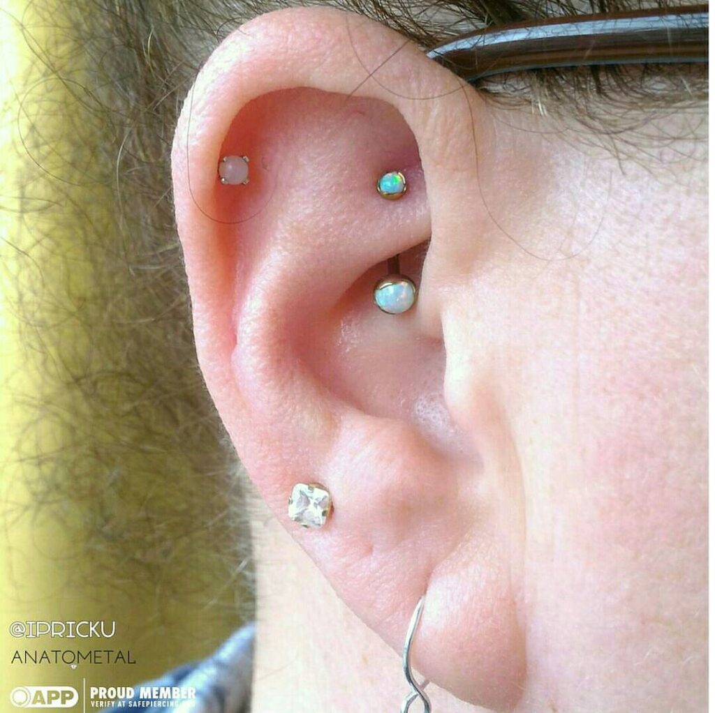 Rook Piercing in Staten Island, NYC | Professional Piercing Close-up of a rook piercing featuring a J-curve barbell with white opal ends from Anatometal, highlighting the unique jewelry choice and precise placement.