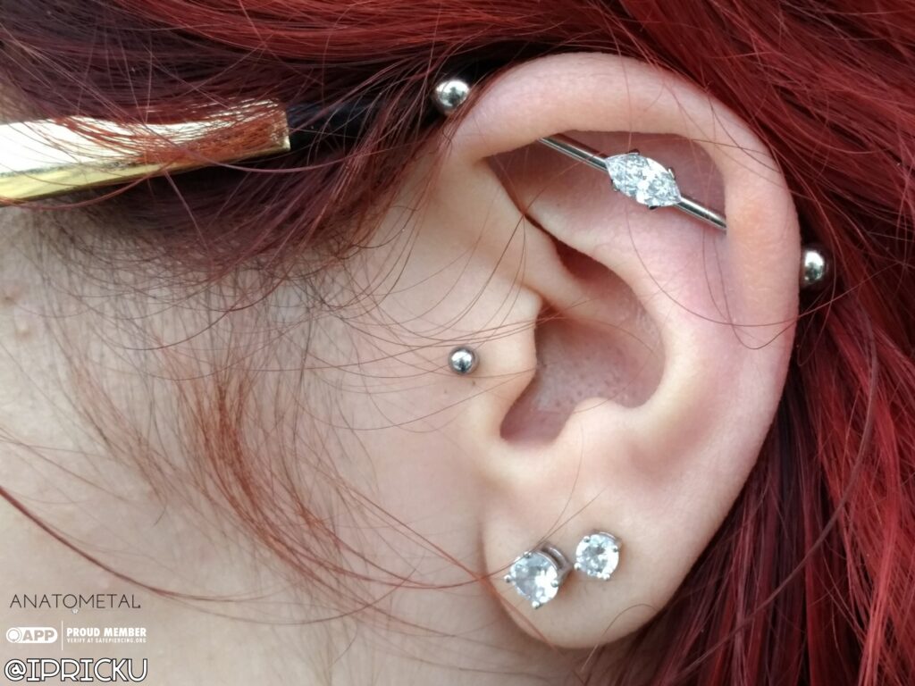 Healed industrial piercing featuring a double-sided marquise-cut cubic zirconia barbell from Anatometal, showcasing elegant design and precise placement.