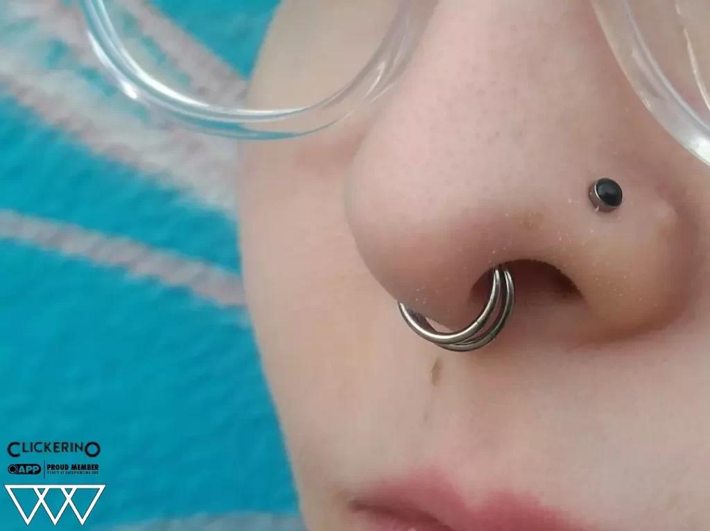 Close-up of a septum piercing featuring two stacked 18g titanium clicker hoops from Clickerino, showcasing a bold and stylish statement.